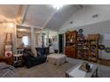 Inviting living room with vaulted ceiling, cozy seating, and decorative shelving at 105 Wade Ct, Summerville, SC 29486