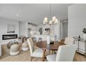 Open-concept floorplan with a fireplace, a modern kitchen with an island, and a dining area with a chandelier at 114 Brown Swiss Cir, Summerville, SC 29483