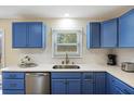 Modern kitchen with beautiful blue cabinets, stainless steel appliances, and bright white countertops at 1264 Fort Dr, Hanahan, SC 29410