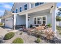Cozy front porch with comfortable seating and beautiful landscaping; the perfect spot for relaxing at 134 Country Oaks Ln, Wando, SC 29492