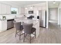 Open kitchen boasts stainless appliances, granite countertops, and a central island with seating at 135 Royal Cainhoy Way, Huger, SC 29450