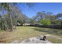 Large backyard with mature trees and wood privacy fence at 1634 Sumner Ave, North Charleston, SC 29406
