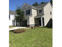 Beautiful home with a spacious front yard, stone accents, and a two-car garage at 176 Daniels Creek Cir, Goose Creek, SC 29445