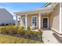 Inviting front porch featuring classic rocking chairs and a beautifully landscaped garden bed at 2025 Elvington Rd, Johns Island, SC 29455