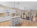 Open-concept kitchen featuring white cabinetry, granite countertops, and a breakfast bar at 2025 Elvington Rd, Johns Island, SC 29455