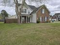 Inviting two-story home with a classic brick and siding exterior, covered entry, and grassy front yard at 223 Westbrooke Rd, Summerville, SC 29486