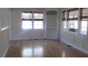 Bright living room with refinished hardwood floors and many windows with woven shades at 2231 Burris Rd, Charleston, SC 29414