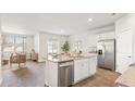 Bright, open kitchen with granite countertops, stainless steel appliances, and view to adjacent living room at 2279 Macallan Blvd, Ravenel, SC 29470