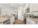 Modern kitchen featuring granite countertops, stainless steel appliances, and white cabinetry at 2279 Macallan Blvd, Ravenel, SC 29470