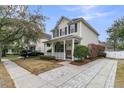 Charming two-story home with a covered front porch, manicured landscaping, and a paved driveway at 2369 Chadbury Ln, Mount Pleasant, SC 29466