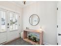 Bright entryway with a stylish console table, a round mirror, and ample natural light streaming in through the front door at 2916 Cavalcade Cir, Johns Island, SC 29455