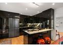 Modern kitchen features high-gloss cabinetry, stainless steel appliances, and a sleek breakfast bar at 301 Broad St # 1, Charleston, SC 29401