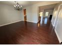 An open-concept living room showcases stunning hardwood floors and is bathed in natural light at 3059 Adventure Way, Ladson, SC 29456