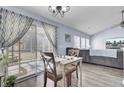 Cozy dining area with sliding doors leading to a screened porch and backyard at 306 Slow Mill Dr, Goose Creek, SC 29445