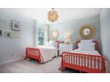 Bright bedroom featuring two beds, decorative mirrors, and neutral tones at 313 Pine Crest View Dr, Summerville, SC 29486