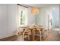 Elegant dining area with a wooden table, seating for six, and a stylish pendant light at 313 Pine Crest View Dr, Summerville, SC 29486