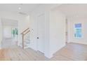 Spacious living area featuring hardwood floors, neutral paint, and staircase to the second level at 3285 Johnstowne St, Johns Island, SC 29455