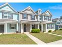 Colorful townhomes boast vibrant exteriors, lush green lawns, and inviting covered front porches at 407 Stoneleigh Ln, Moncks Corner, SC 29461