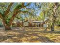 Charming brick home with mature trees, and a beautiful front yard landscape at 562 Fort Johnson Rd, Charleston, SC 29412