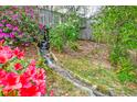 Picturesque water feature surrounded by vibrant azaleas and lush greenery at 6019 Rembert Dr, Hanahan, SC 29410