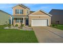 Inviting two-story home featuring a well-maintained lawn and a convenient two-car garage at 607 Silver Spruce St, Summerville, SC 29486