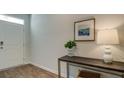 Inviting entryway with wood-look flooring, table decor, a contemporary lamp and a piece of wall art at 6230 Gritman Dr, Hollywood, SC 29470