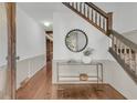 Inviting foyer with hardwood floors, elegant staircase, and stylish console table creates a warm and welcoming entrance at 741 Creekside Dr, Mount Pleasant, SC 29464
