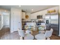 The dining area showcases hardwood floors and stainless steel appliances at 8018 Rackham Rd, Hollywood, SC 29470