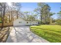 Single story home featuring a long driveway and a well manicured lawn at 914 King Richard Dr, Charleston, SC 29407