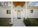 Inviting front entrance with a modern light blue door and stylish sconces at 914 King Richard Dr, Charleston, SC 29407