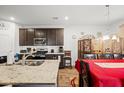 Well-equipped kitchen with granite countertops, stainless steel appliances, a kitchen island, and an adjacent dining area at 103 Cotesworth Ct, Summerville, SC 29486