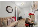 Inviting living room showcasing an ornate clock, console table, rug, and comfortable sofa with decorative pillows at 103 Cotesworth Ct, Summerville, SC 29486