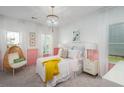 Cozy bedroom features pink accents, a stylish light fixture, and plush furnishings at 1058 Tea Time Dr, Summerville, SC 29485