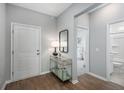 Bright entryway with wood floors, stylish console table, and views into the bedroom and bathroom at 1058 Tea Time Dr, Summerville, SC 29485
