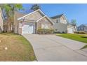 The home boasts a stone facade, garage and an inviting curb appeal enhanced by a green lawn at 108 Chemistry Cir, Ladson, SC 29456
