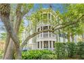 Stunning multi-story home showcasing architectural details and lush landscaping, offering a serene and inviting curb appeal at 1325 Telfair Way, Charleston, SC 29412