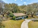 An aerial view showcasing the property, its expansive yard, and mature trees surrounding the home at 1515 Devons St, Charleston, SC 29412