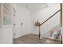 Inviting entryway with neutral tones, wood-look flooring, a bench, a staircase and tasteful decorations at 1827 Nola Run, Summerville, SC 29485