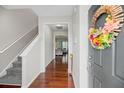 Inviting entryway features hardwood floors, staircase, and a decorative wreath on the front door at 184 Charlesfort Way, Moncks Corner, SC 29461