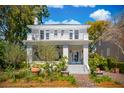 Traditional-style home featuring a small, covered porch, balcony, and manicured landscaping at 184 Tradd St, Charleston, SC 29401