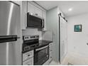 This modern kitchen features stainless steel appliances and easy access to the laundry area with sliding doors at 2011 N Highway 17 # 1400 J, Mount Pleasant, SC 29466