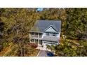 Captivating aerial view of the home with a cozy front porch, lush landscaping, and a private driveway at 2107 Nicholas David Path, Johns Island, SC 29455