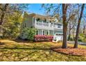 Inviting two-story home with a charming porch, manicured lawn, and mature landscaping, perfect for serene outdoor living at 2107 Nicholas David Path, Johns Island, SC 29455