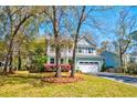Beautiful two-story home featuring a welcoming front porch, manicured lawn, and a private driveway at 2107 Nicholas David Path, Johns Island, SC 29455