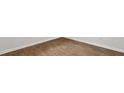 View of the beautiful light brown wood-look flooring with white walls and baseboards at 2179 Macallan Blvd, Ravenel, SC 29470