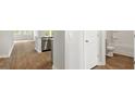 Hallway view of an open-concept design with new wooden floor, stainless steel appliances, and white bathroom at 2179 Macallan Blvd, Ravenel, SC 29470