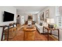 Open-concept living room with hardwood floors, modern furniture, and ample natural light at 223 Grove St, Charleston, SC 29403