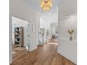 Bright hallway with hardwood floors, white walls, and a staircase leading upstairs at 233 Ashmont Dr, Wando, SC 29492