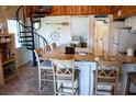 Charming kitchen with granite countertops, bar seating, and a spiral staircase to the second level at 259 Sea Cloud Cir, Edisto Island, SC 29438