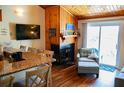 Comfortable living area with a fireplace, wood walls, and sliding glass doors to the outside at 259 Sea Cloud Cir, Edisto Island, SC 29438